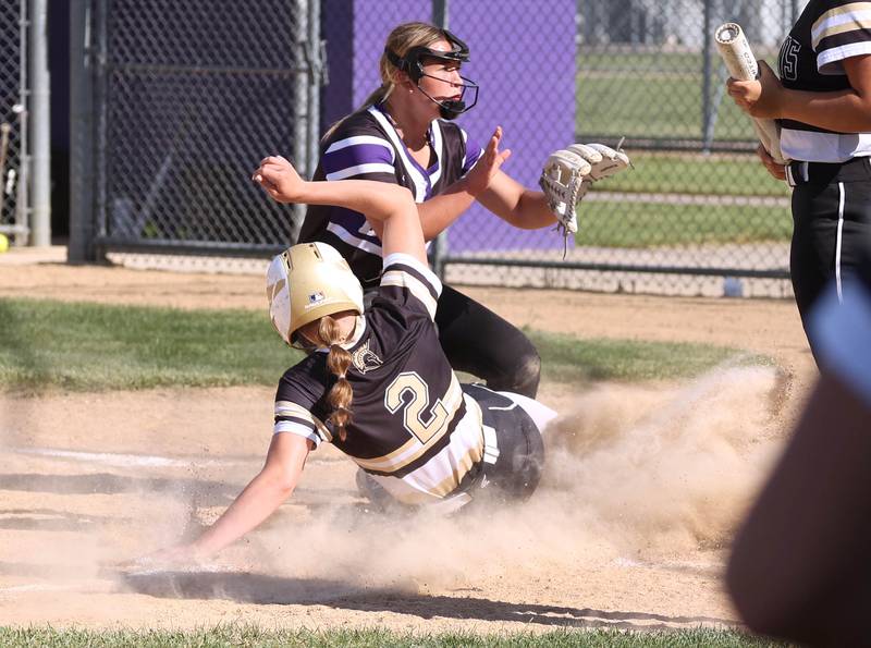 Sycamore's Brighton Snodgrass scores a run on a wild pitch as Dixon’s Abby Hicks waits for the throw during their Class 3A regional championship game Thursday, May 23, 2024, at Rochelle High School.