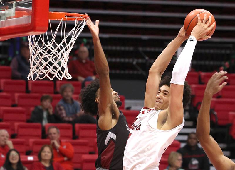 Northern Illinois' Yanic Konan Niederhauser goes to the basket against Calumet's Joshua Morris during their game Monday, Dec. 18, 2023, at the Convocation Center at NIU in DeKalb.