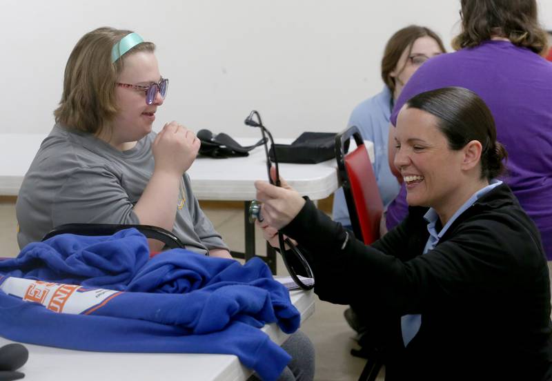 Megan Valo, EMT Basic student (right) holds a stethoscope before taking Alyssa Flueck's blood pressure on Thursday, March 7, 2024 at the McNabb Fire Department. EMT Basic students trained with special needs students in Putnam County on how to work with the special needs kids so they will feel more comfortable and understand what will happen in an emergency. The training gave the EMT Basic students hands-on training on working with the special need students.