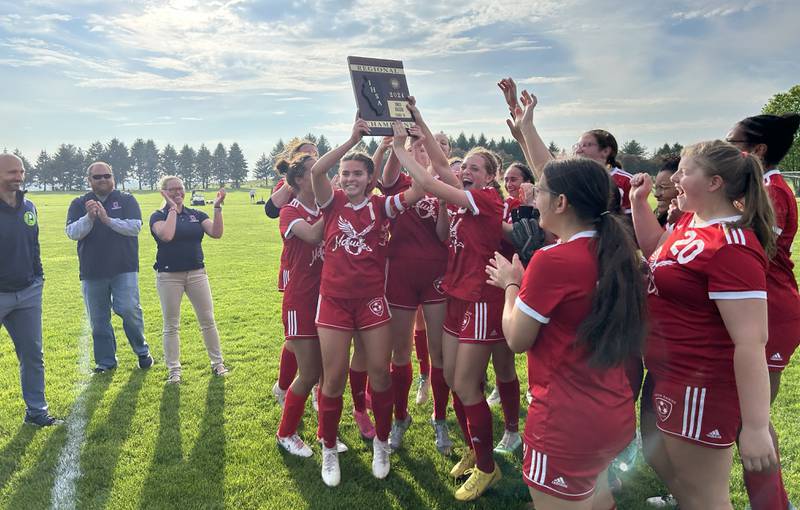 The  Hawks' soccer team celebrates with their regional trophy after downing Aurora Central Catholic 4-1 to win the 1A Oregon Regional on Tuesday, May 14, 2024 at Oregon Park East. With the win, the Hawks boosted their record to 18-1 and will face Stillman Valley at. the Shabbona (Indian Creek) Sectional on Saturday, May 18.  Game time is noon.