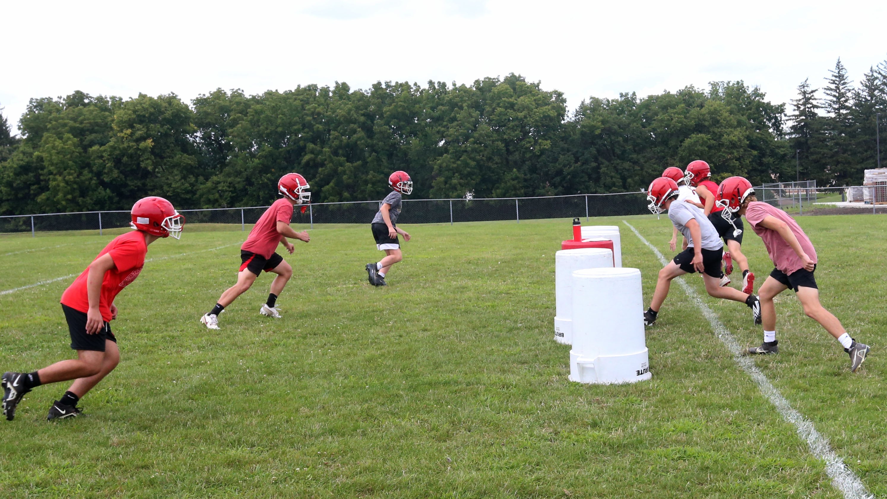 Members of the Hall football team run drills during the first day of practice on Monday, Aug. 12, 2024 at Hall High School.