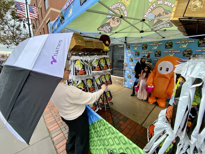 Anahi Dominguez, Lizbeth Mora, 9, Brian Mora and Pedro Mora, of DeKalb, pose at There's Fun In Store's photo booth outside the shop, 229 E. Lincoln Highway, during the 26th annual Spooktacular downtown trick-or-treating event hosted by the DeKalb Chamber of Commerce on Thursday, Oct. 26, 2023.