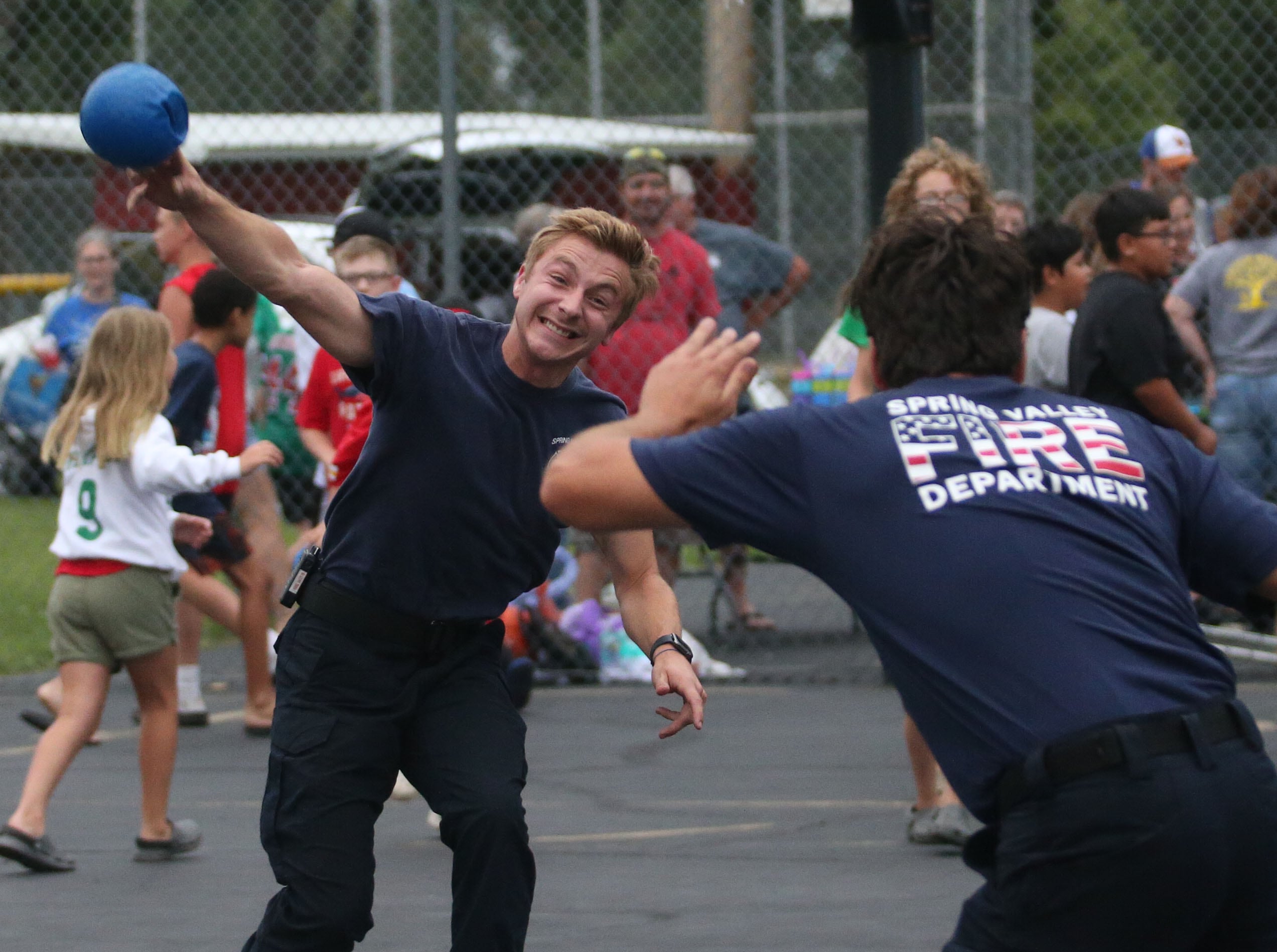 Josh Switek whips a dodgeball at other Spring Valley firefighters during a game of kids versus Spring Valley firefighters during  the National Night Out event on Tuesday, Aug. 6, 2024 at Kirby Park in Spring Valley.