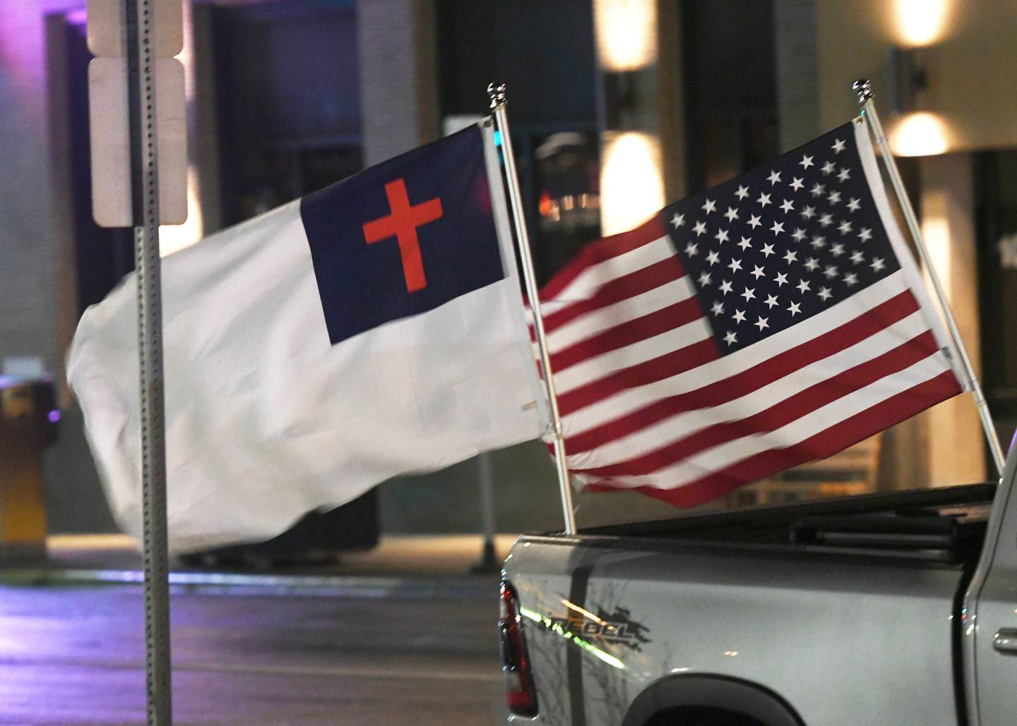 Gary Schrimpsher's truck displayed a Christian flag and a U.S. flag during a candlelight prayer vigil for the Ukrainian people on the east lawn of the Ogle County Courthouse on Saturday night. Schrimpsher was one of the organizers of the event. A christian flag is an ecumenical flag designed in the early 20th century to represent much of Christianity and Christendom.