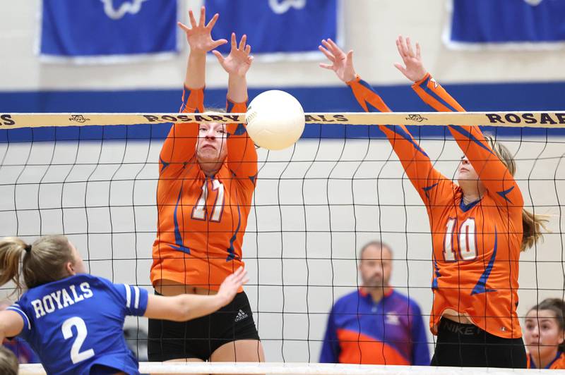 Genoa-Kingston's Lily Mueller (left) and Rylie Stoffregen  try to block the spike of Rosary's Lily Caruso during their Regional semifinal match Tuesday, Oct. 25, 2022, at Rosary High School in Aurora.