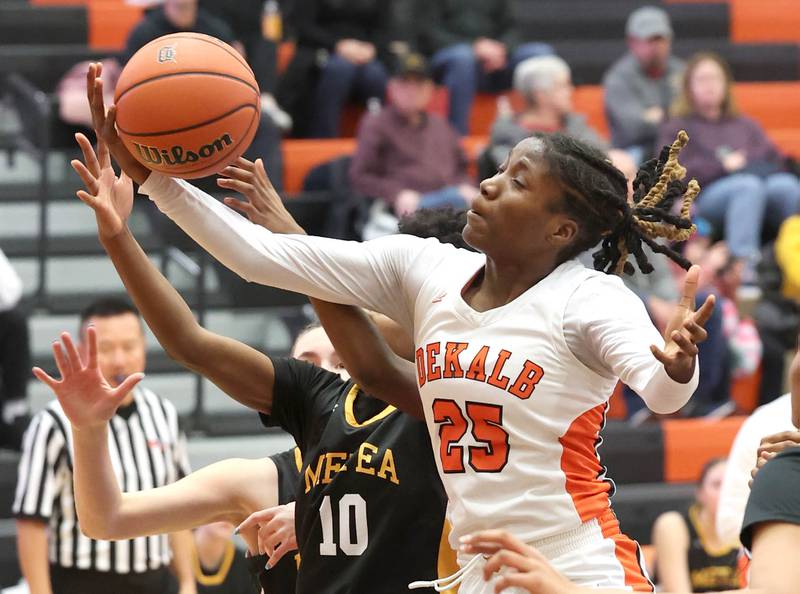 DeKalb’s Kezaria Mitchell grabs a rebound over Metea Valley's Arainna Hammons during their game Friday, Jan. 19, 2024, at DeKalb High School.