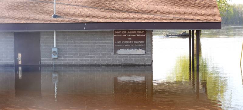 Floodwaters from the Mississippi River surround a building at the public boat docks in Albany on Thursday as water levels continued to rise.