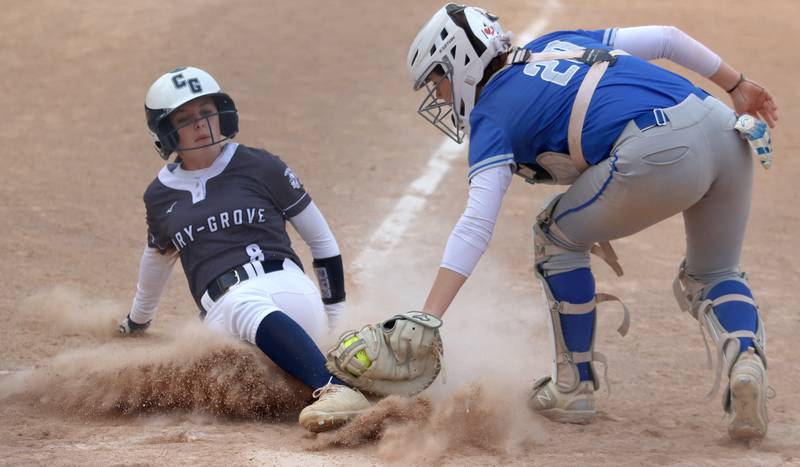 Cary-Grove’s Holly Streit, left, is out at home as Burlington Central’s Ava Brzezicki applies the tag in varsity softball at Cary Monday.