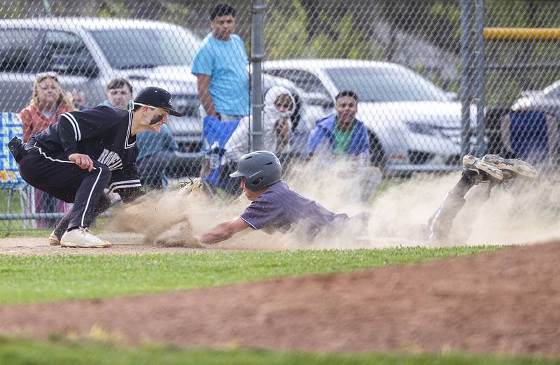 Dixon’s Alex Harrison slides in safe with a triple as Rock Falls’ Ethan Moeller comes down with a tag  Monday, April 22, 2024 in Dixon.