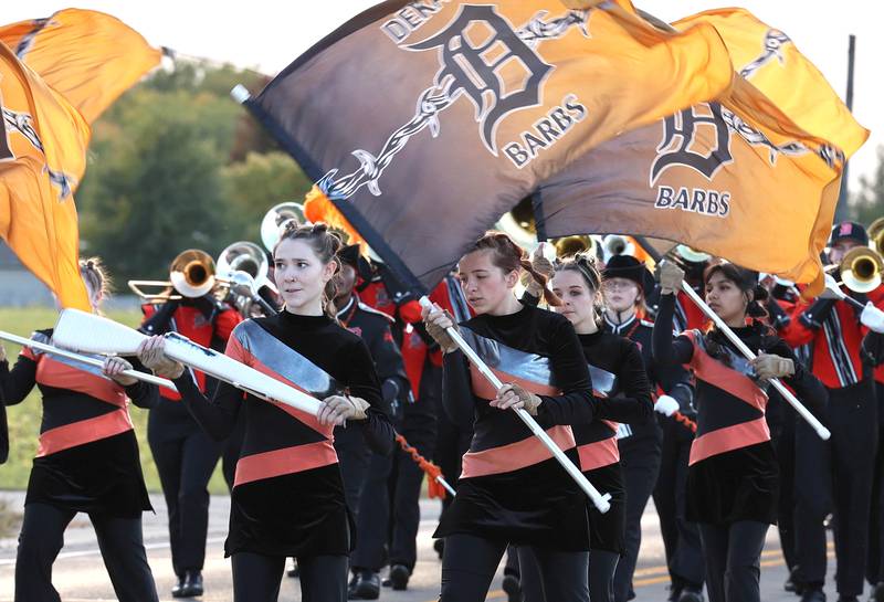 Members of the DeKalb High School flag team march down Dresser Road Wednesday, Oct. 5, 2022, during the school's homecoming parade.