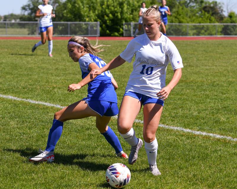 St. Charles North's Chloe Kirsten (10) gets the ball away from Wheaton North's Grace Kuczaj (13) during the sectional title game on Saturday May 25, 2024, held at South Elgin High School.