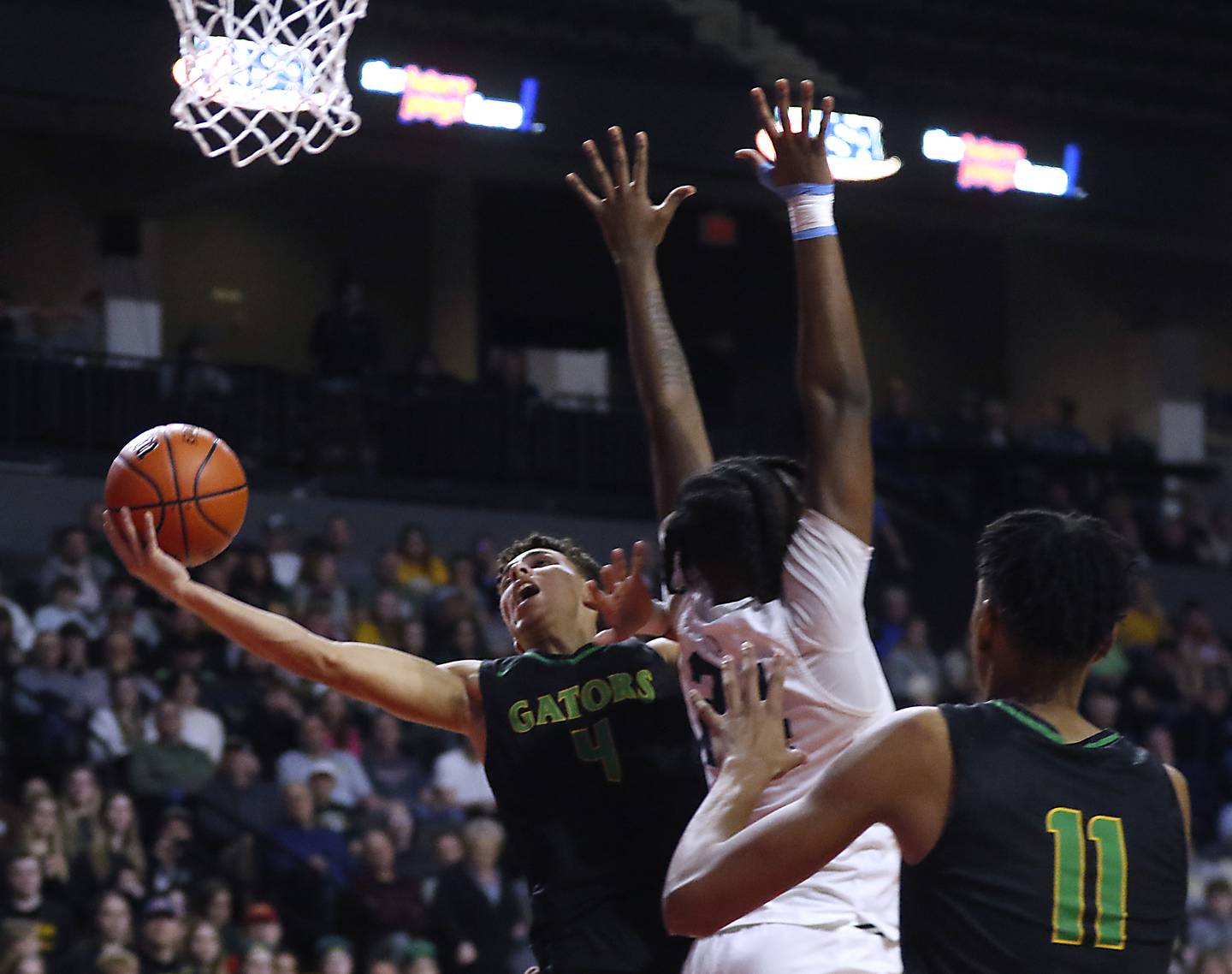 Crystal Lake South's AJ Demirov drives to the basket against DePaul College Prep's Rashaun Porter during the IHSA Class 3A Supersectional basketball game on Monday, March 4, 2024, at NOW Arena in Hoffman Estates.