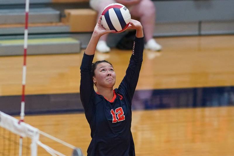 Oswego’s Ava Flanigan (12) sets the ball during a volleyball match against Rosary at Oswego High School on Tuesday, Sep 3, 2024.