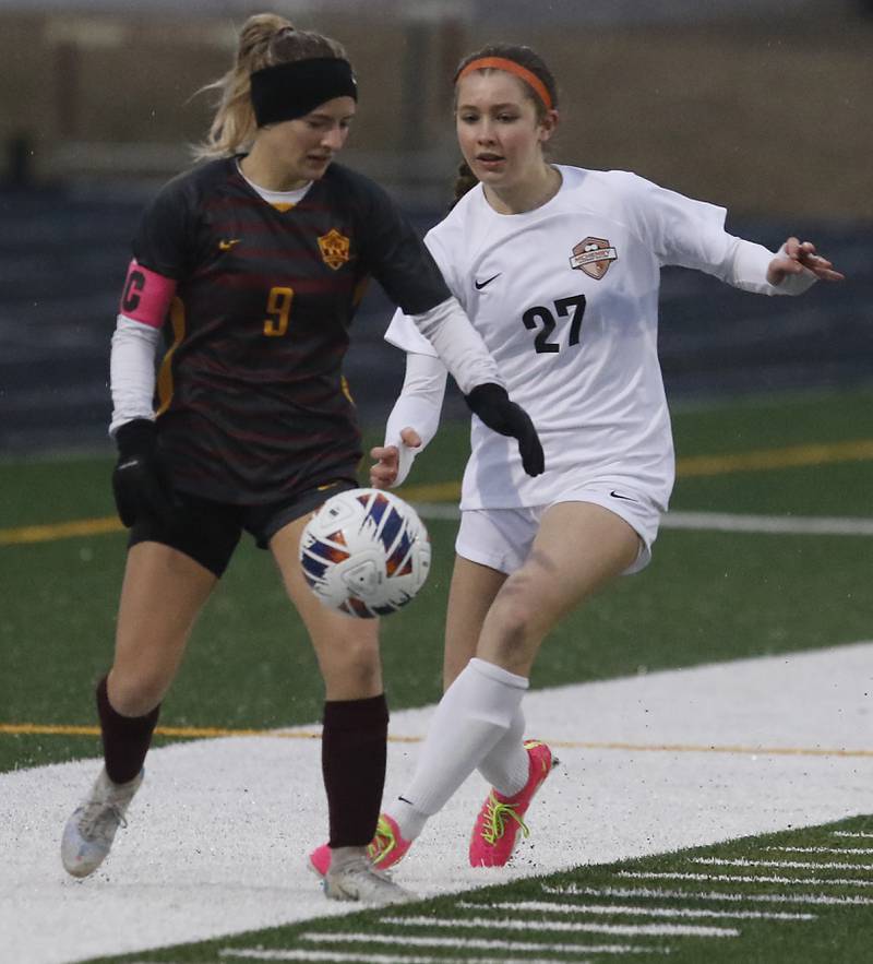 Richmond-Burton's Reese Frericks tries to control the ball in front of McHenry’s Addison Michelau during a non-conference girls soccer match Thursday, March 16, 2023, at Richmond-Burton High.