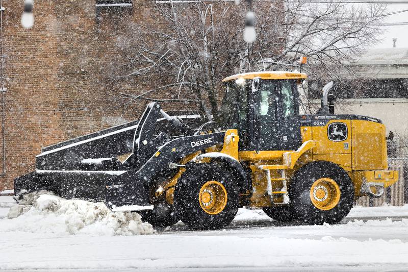 Snow clearing equipment works in a downtown Sterling parking lot Tuesday, Jan. 9, 2024 as the first big snow fall of the winter socks the Sauk Valley.