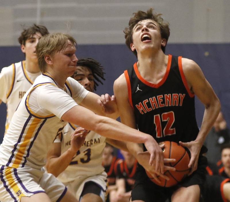 McHenry's Caleb Jett is fouled by Hononegah's Cole Warren during the IHSA Class 4A Guilford Boys Basketball Sectional semifinal game on Wednesday, Feb. 28, 2024, at Rock Valley College in Rockford.