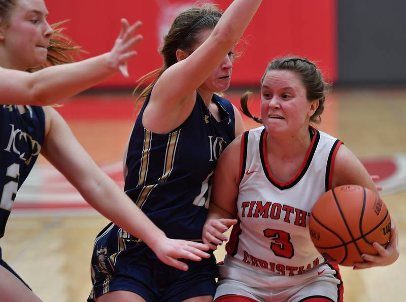 Timothy Christian's Mili Martens (3) is pressured by IC Catholic's Kelsey McDonough and Maura Grogan (left) during the Class 2A Timothy Christian Regional championship game on Feb. 17, 2023 at Timothy Christian High School in Elmhurst.