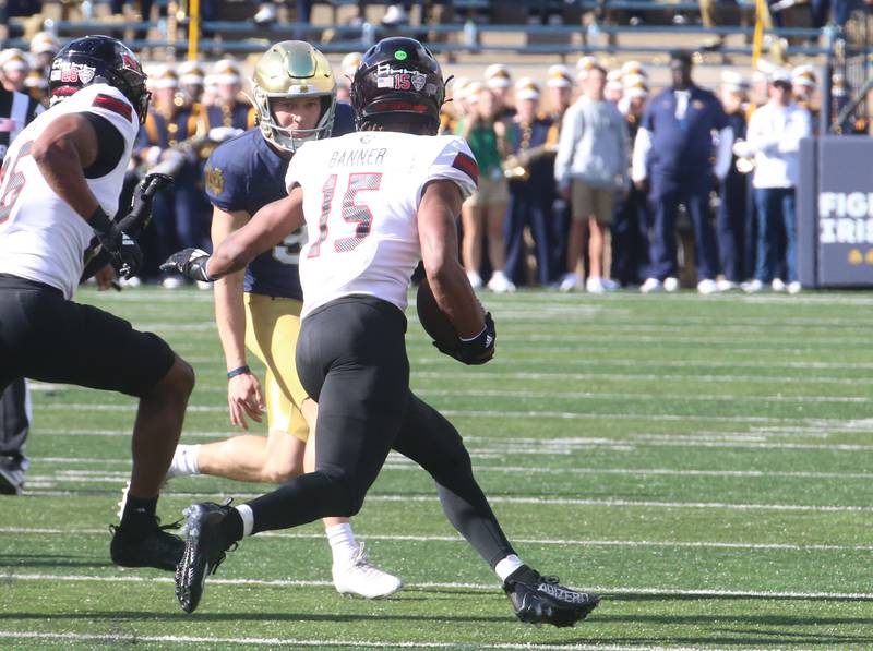 NIU's Santana Banner carries the ball as Notre Dame's Mitchell Evans looks to make the tackle on Saturday, Sept. 7, 2024 at Notre Dame Stadium.