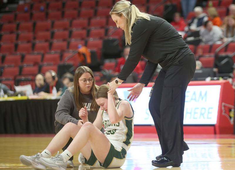 St. Bede head girls basketball coach Stephanie Mickley helps up player Lili McClain off of the floor during the Class 1A State semifinal game on Thursday, Feb. 29, 2024 at CEFCU Arena in Normal.
