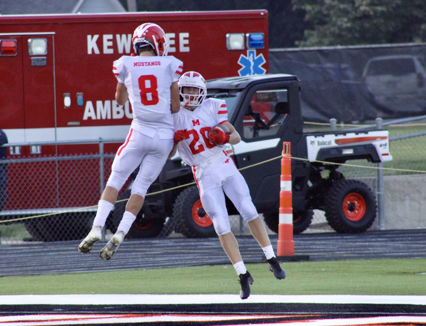 Morrison tight end Brady Anderson (20) celebrates his touchdown with teammate Blake Adams (8) on Friday in Kewanee. It was the first game played on Kewanee's renovated field with artificial turf and new stadium lights. Kewanee won 16-14.