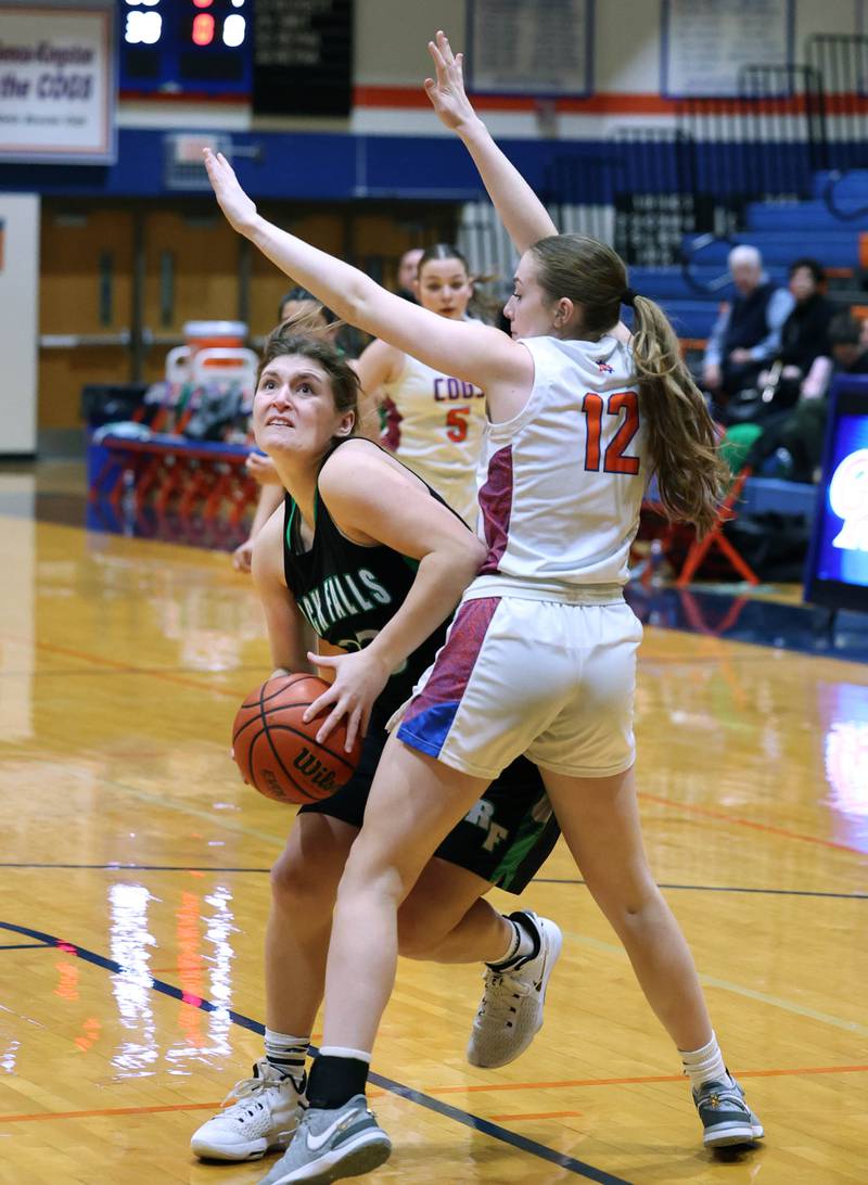 Rock Falls' Claire Bickett tries to get around Genoa-Kingston's Ally Poegel during their game Friday, Feb. 2, 2024, at Genoa-Kingston High School.