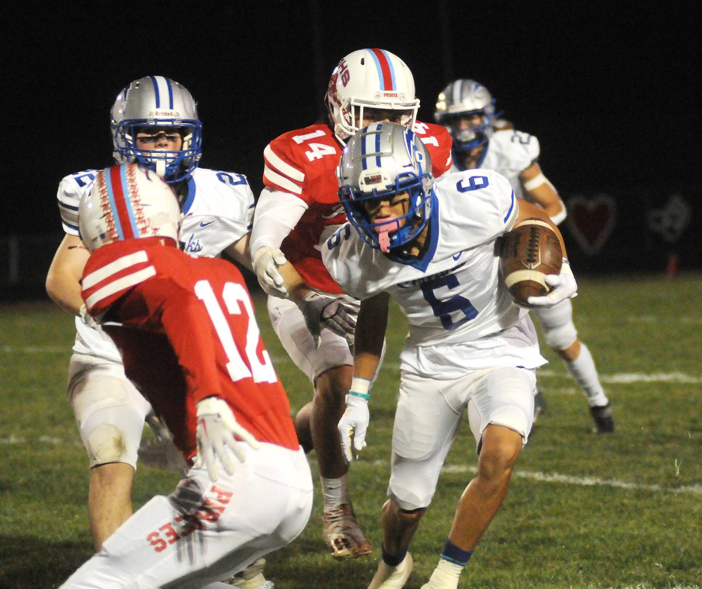 Woodstock ball carrier Charles Gilmore (6) tries to get past the Ottawa defense of Conner Price (12) and Trey Donnely at King Field on Friday, Oct. 21, 2022.