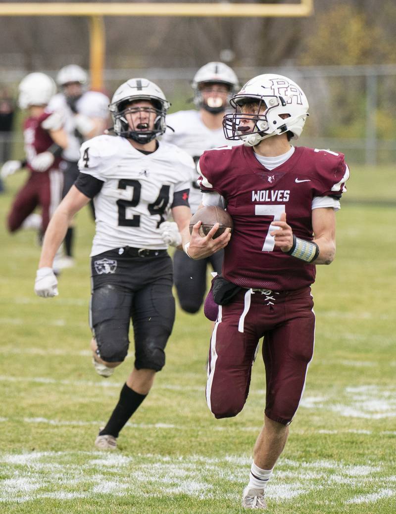 Prairie Ridge quaterback Tyler Vasey checks over his shoulder as he outruns Kaneland's Anthony Urban for a touchdown in the 3rd quarter during the 6A second-round football playoff game on Saturday, November 5, 2022 at Prairie Ridge High School in Crystal Lake. Prairie Ridge won 57-22.