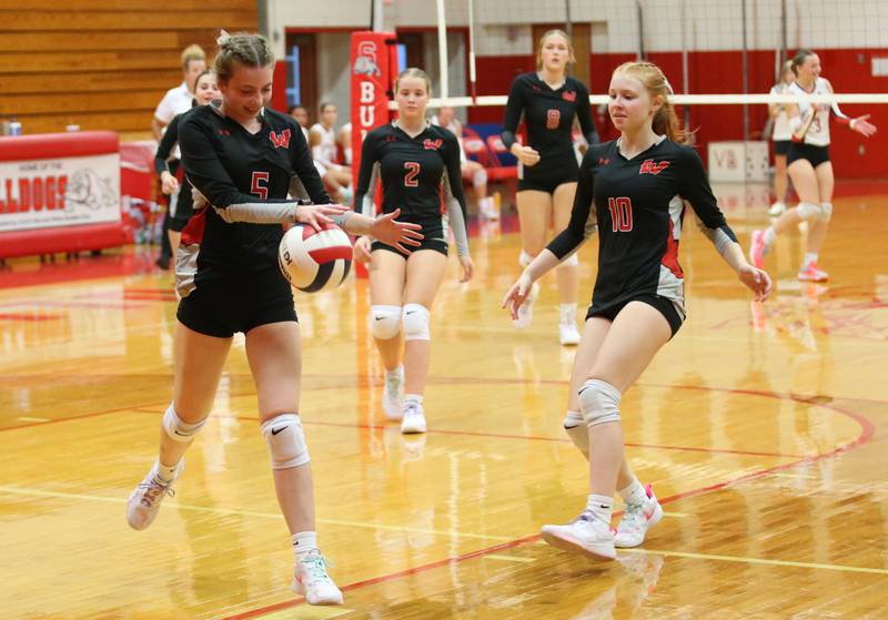 Woodland volleyball players (from left) Layna Wilcoxen, Ella Derossett and Gabby Jacobs chase after the ball as it stays in bounce behind them while playing Streator on Monday, Aug. 26, 2024 at Streator High School.