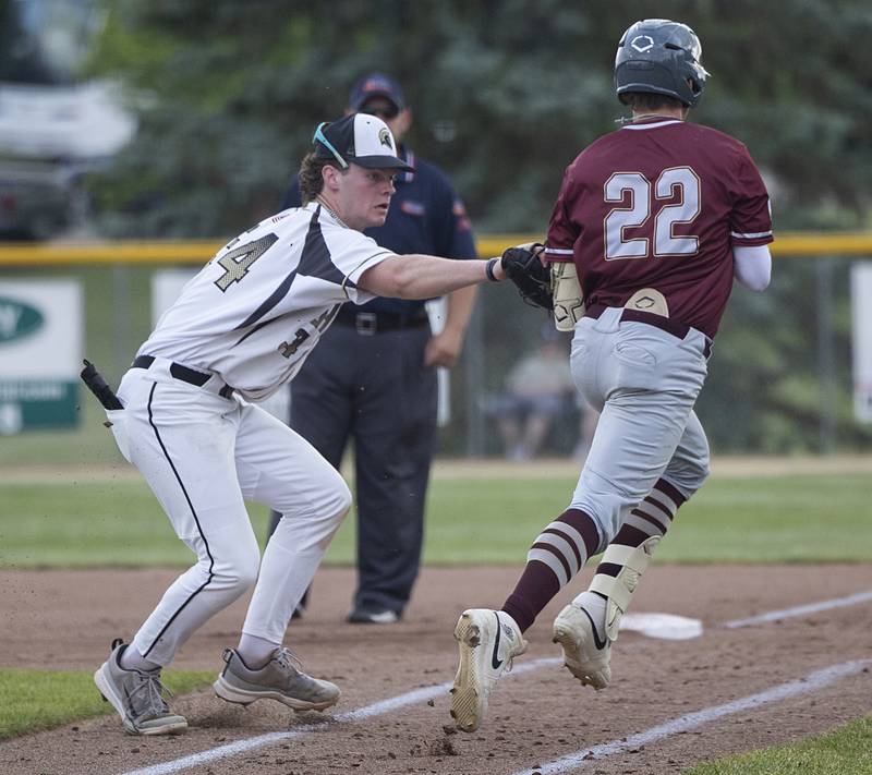 Sycamore’s Davis Collie tags out Morris’ Brett Bounds on a bunt play Monday, June 3, 2024 in the Class 3A Geneseo supersectional.