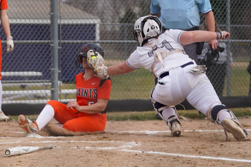 Oswego East's Ryenne Sinta (21) tags St. Charles East's Hayden Sujack (21) for an out on a play at the plate during a softball game at Oswego East High School on Wednesday, March 13, 2024.