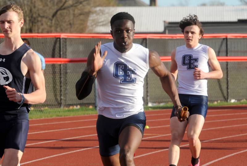 Oswego East's Stephen Sarfo takes the baton from teammate Tristan Baur in the 4x100 Meter Relay during the Matt Wulf Track and Field Invitational at Yorkville High School on Friday, April 12, 2024.