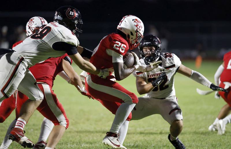 South Elgin's DeAngelo McCullough (26) looks for room to move around Barrington's Michael Audino (32) Friday, Aug. 30, 2024 in South Elgin.