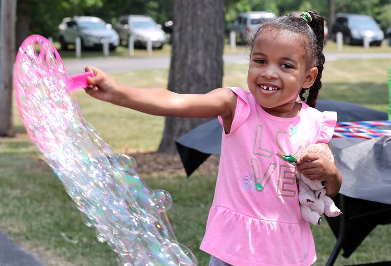 Versa Sheko, 4, from DeKalb, plays with some bubbles at the Cortland booth during the Juneteenth Community Celebration Sunday, June 18, 2023, at Hopkins Park in DeKalb. The event featured vendors, food, music, games, and more.