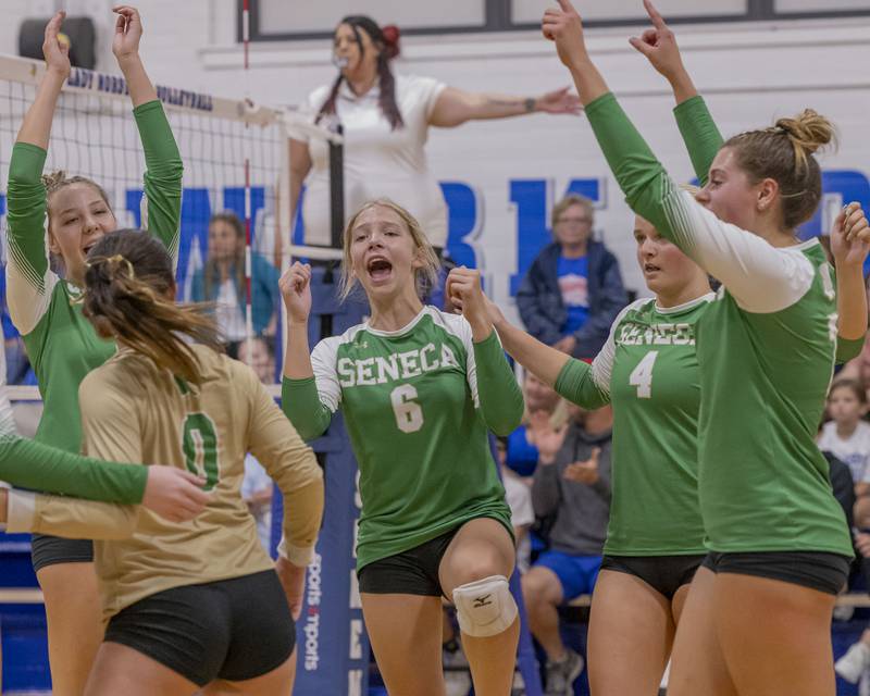 Seneca athletes celebrate the winning set point and forcing a third set against Newark Community High School on September 9, 2024.