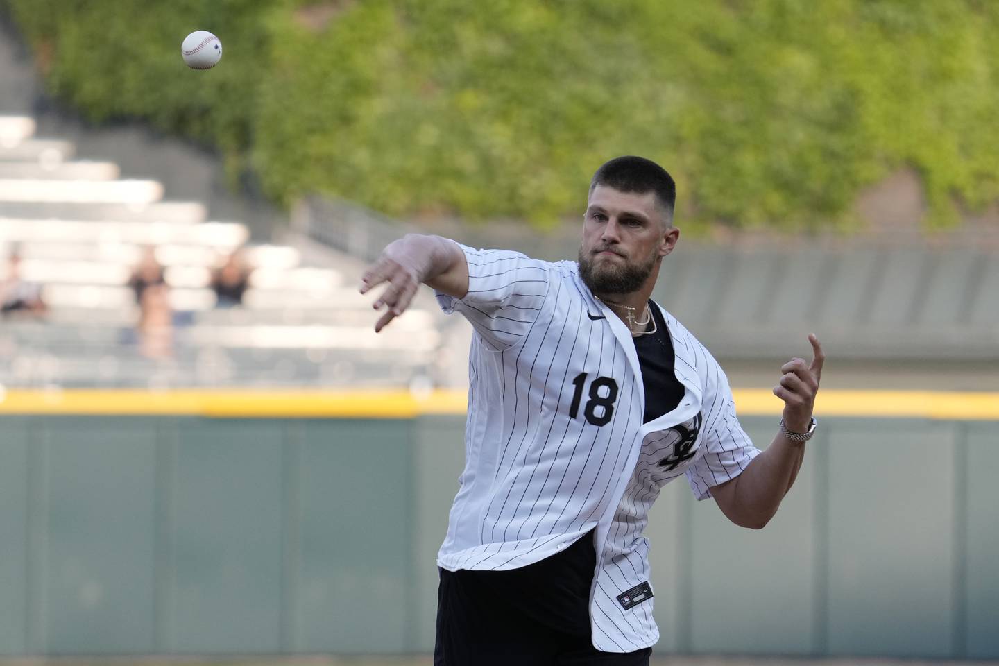 Chicago Bears tight end Robert Tonyan Jr., throws out a ceremonial first pitch before a baseball game between the Texas Rangers and the Chicago White Sox, Tuesday, June 20, 2023, in Chicago.