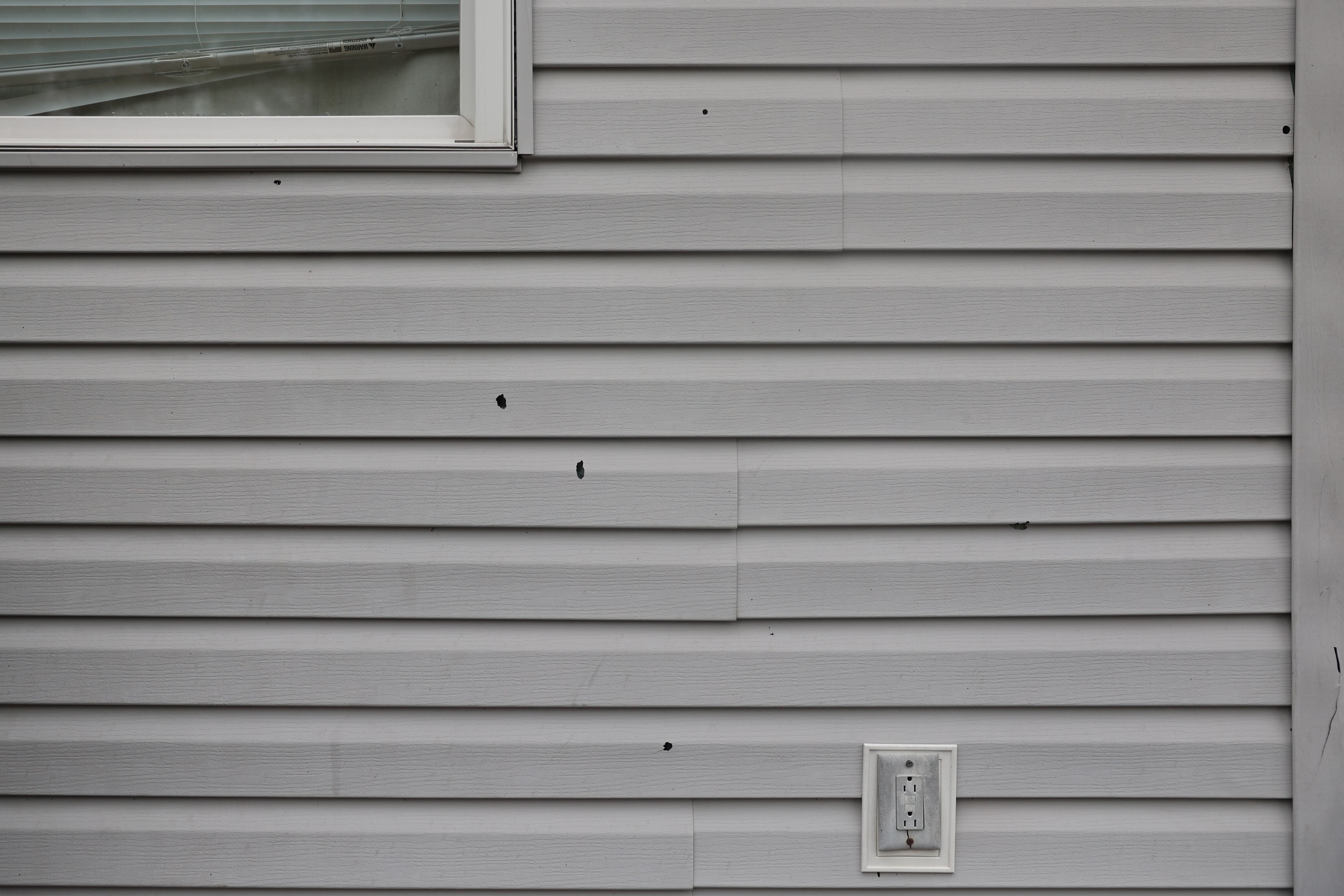 Several bullet holes are visible on the siding of a home. On Wednesday morning July, 24, 2024, Joliet Police responded to shots fired in the 1400 block of North Center Street, Joliet. No injuries were reported.