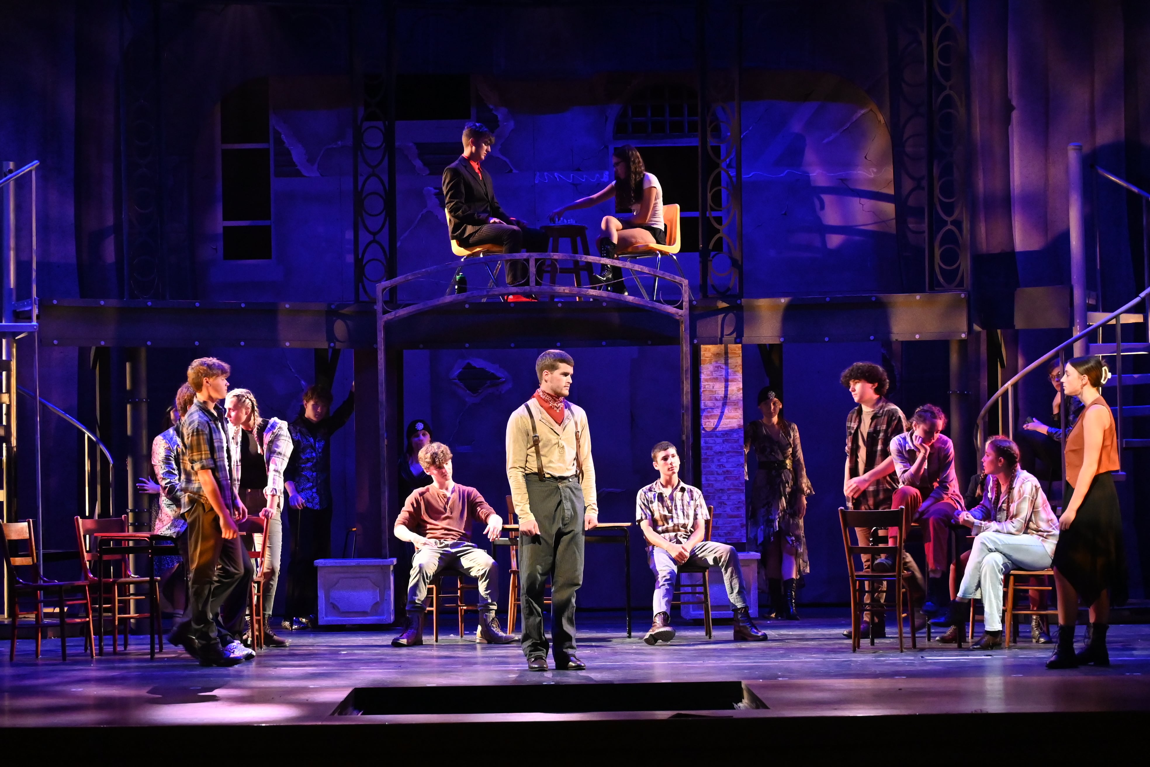 Orpheus, played by Stephen Byers, Jr., surrounded by the rest of the cast of Hadestown, including Elaina Patten on the far right, who plays Eurydice.