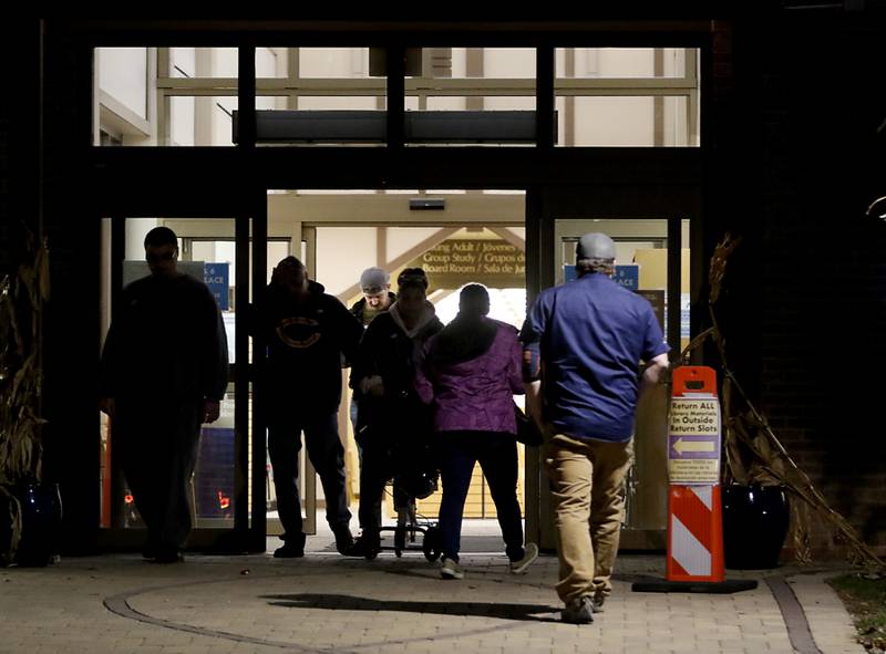 Voters enter and exit the Woodstock Public Library, 414 West Judd Street in Woodstock, on Nov. 8, 2022, to vote in the midterm election.