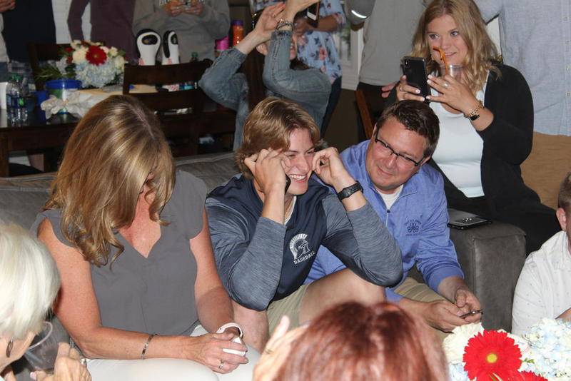 Cary-Grove's Quinn Priester learns of his selection by the Pittsburgh Pirates in the first round of the MLB draft with his mother Chris Priester (left) and father Andy Priester (right).