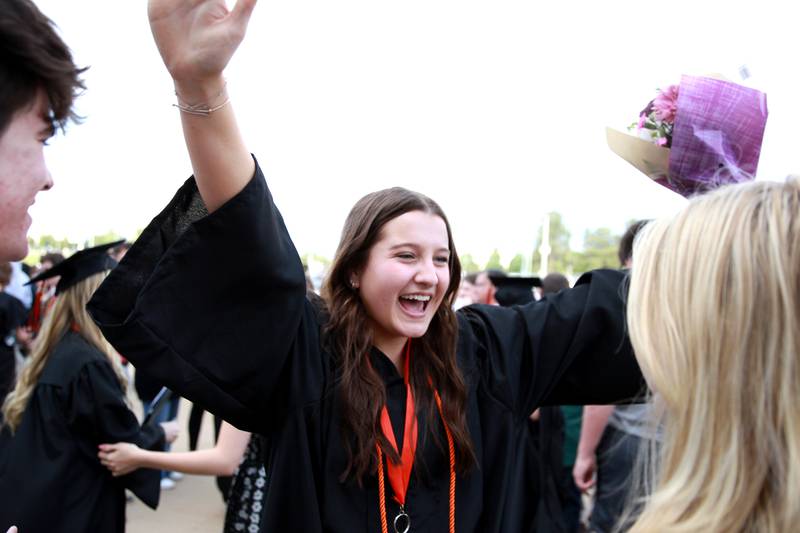 St. Charles East graduate Tatum Smith greets her friends and family following the school’s 2024 commencement ceremony at Northern Illinois University in DeKalb on Monday, May 20, 2024.