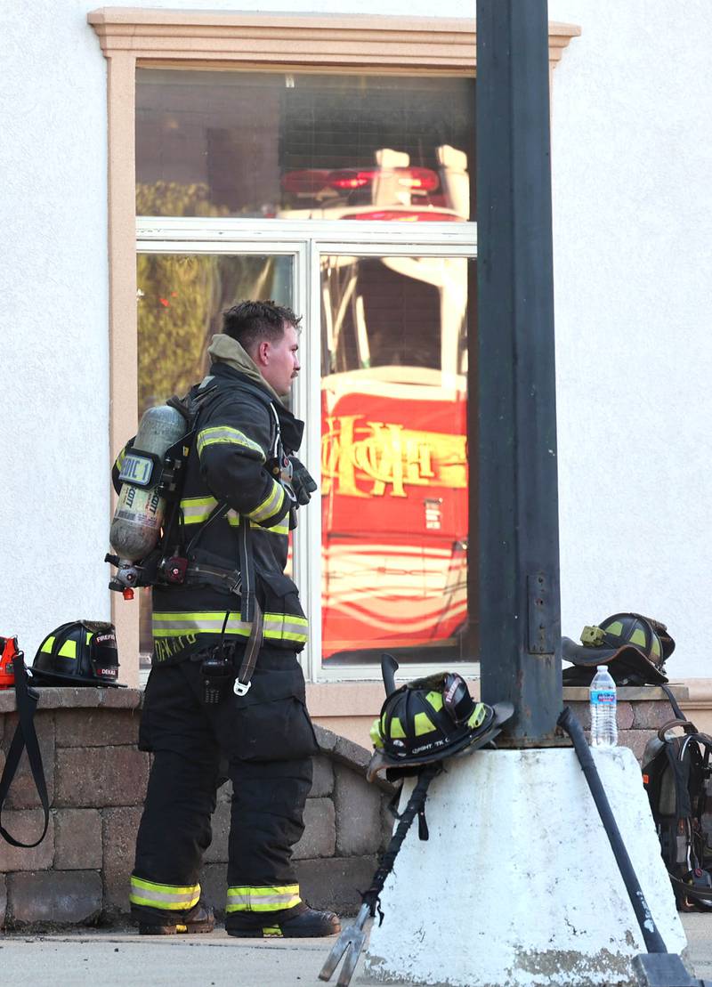 A DeKalb firefighter removes his gear after battling a structure fire Friday, Sept. 1, 2023, in the building that once housed Fanatico Italian restaurant at 1215 Blackhawk Road in DeKalb.