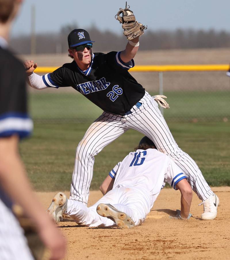 Hinckley-Big Rock’s Saje Beane dives back safely into second under Newark's Clay Friestad Monday, April 8, 2024, during their game at Hinckley-Big Rock High School.