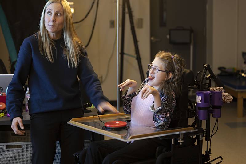 Amy Boss (left), speech and language pathologist at Reagan Middle School, works with student Addy Weidman Thursday, April 6, 2023. Weidman uses a variety of technology in her learning.