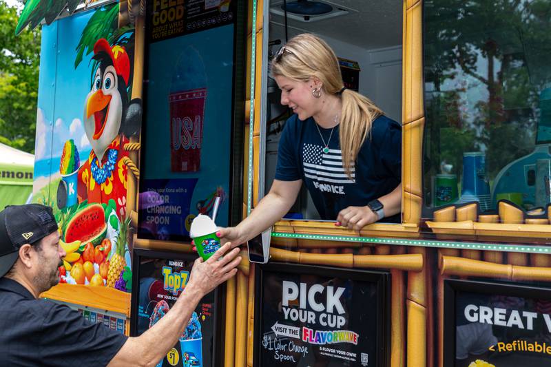 Mackenzie Han with Kona Ice serves a customer at the Hinsdale 4th of July Family Celebration.  July 4th, 2024.