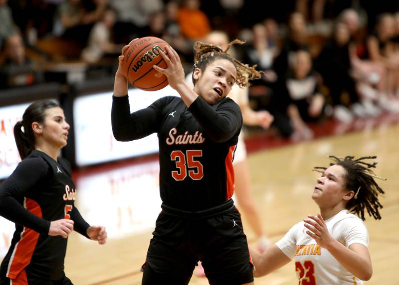 St. Charles East’s Corinne Reed comes down with the rebound during a Class 4A Batavia Sectional semifinal game against Batavia on Tuesday, Feb. 20, 2024.