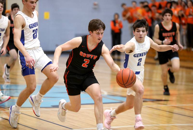 Wheaton Warrenville South’s Drew Berkley (left) drives toward the basket chased down by Geneva’s Gabe Jensen during a Class 4A Willowbrook Regional semifinal game on Wednesday, Feb. 21, 2024.