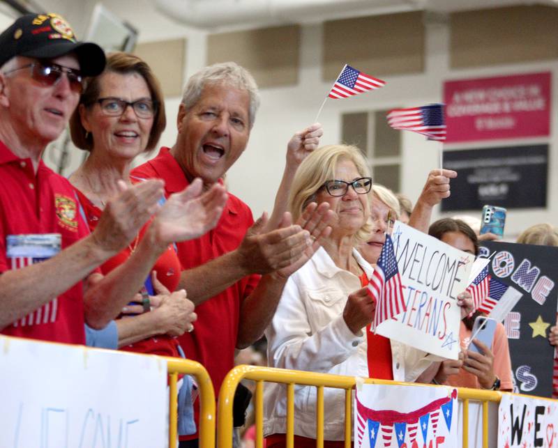 People offer a warm welcome as McHenry Community High School hosted a celebration Sunday for veterans returning from an Honor Flight trip to Washington D.C. The Honor Flight trip was coordinated by the Veterans Network Committee of Northern Illinois.