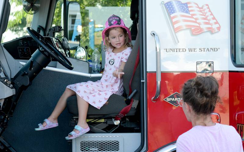 Fiona Wright, 4 of Campton Hills sits in the drivers seat of a fire truck during the Campton Hills National Night Out event on Tuesday, August 2, 2022.