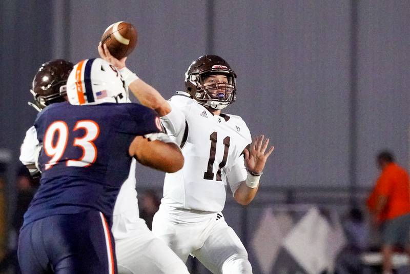 Joliet Catholic's Lucas Simulick (11) throws a pass against Oswego during a football game at Oswego High School on Friday, Sep 6, 2024.