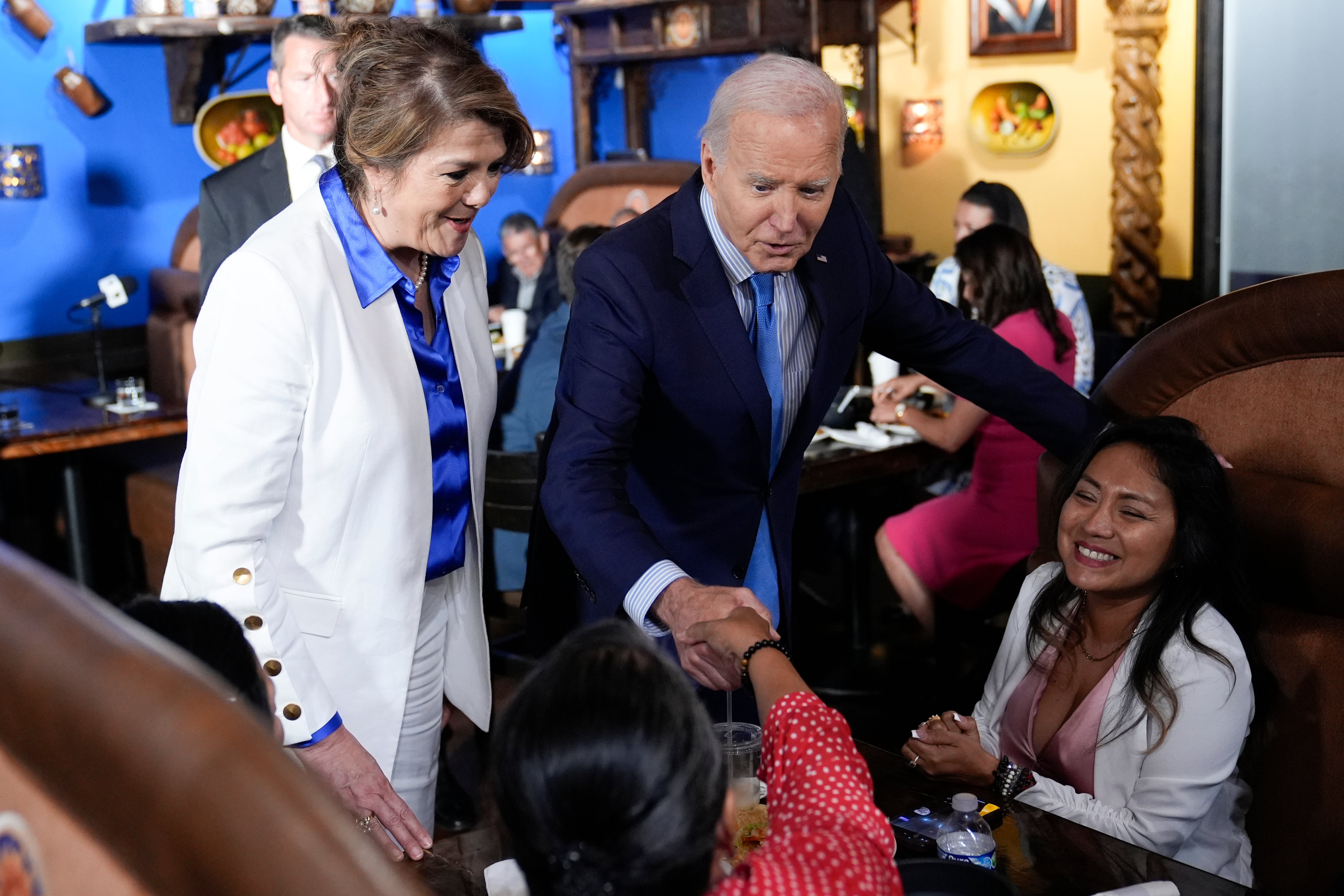 President Joe Biden and Maritza Rodriguez, Biden for President Latina adviser, greets patrons at Linda Michoacan Mexican Restaurant, during a stop in Las Vegas, Wednesday, July 17, 2024. (AP Photo/Susan Walsh)